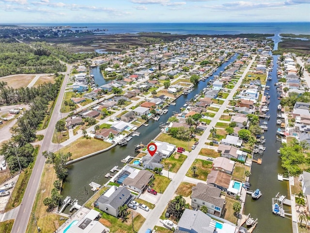 drone / aerial view with a water view and a residential view