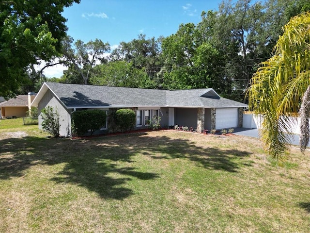 single story home featuring a garage, a front lawn, and driveway