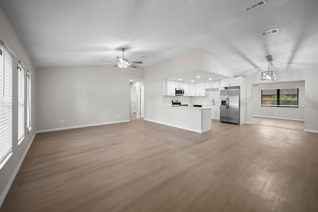 unfurnished living room featuring ceiling fan, visible vents, light wood-style flooring, and vaulted ceiling