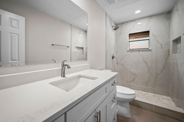 full bathroom featuring vanity, visible vents, wood finished floors, toilet, and a marble finish shower