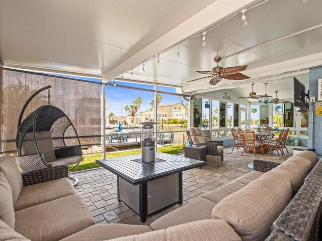 view of patio with an outdoor living space, outdoor dining space, and a ceiling fan