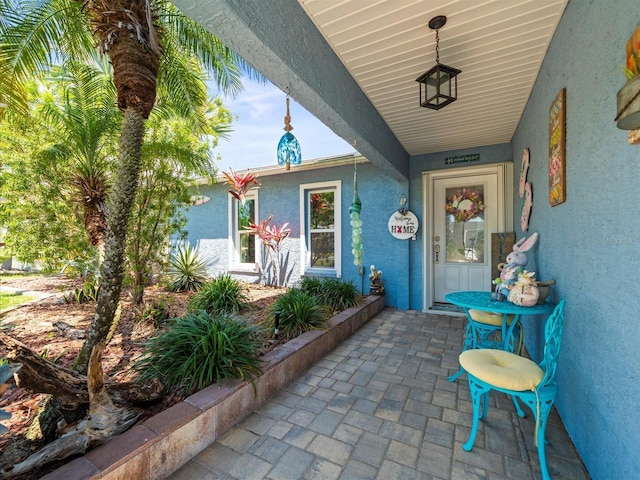 doorway to property featuring stucco siding