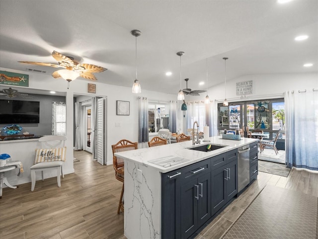 kitchen featuring visible vents, light wood-style flooring, ceiling fan, and a sink