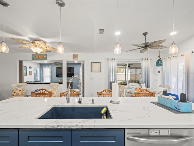 kitchen with blue cabinets, ceiling fan, a sink, and dishwasher