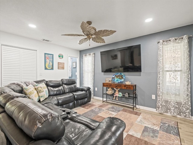 living area with wood finished floors, visible vents, recessed lighting, ceiling fan, and baseboards