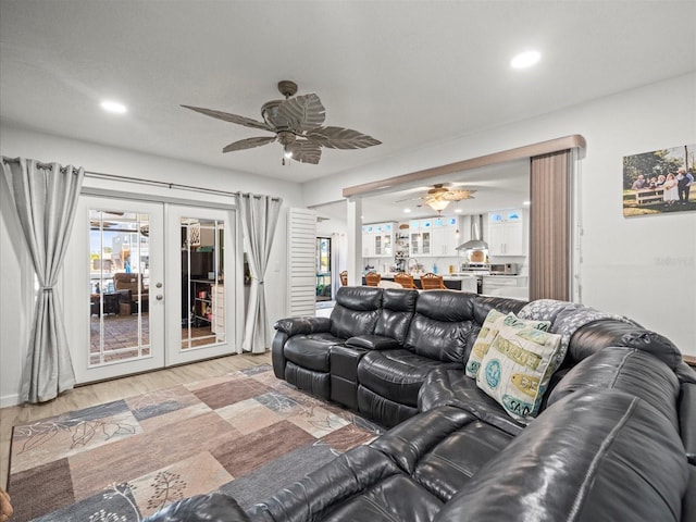 living area featuring light wood-style floors, french doors, ceiling fan, and recessed lighting