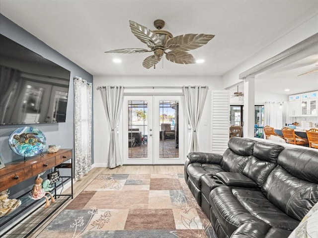 living area featuring french doors, wood finished floors, recessed lighting, a ceiling fan, and baseboards