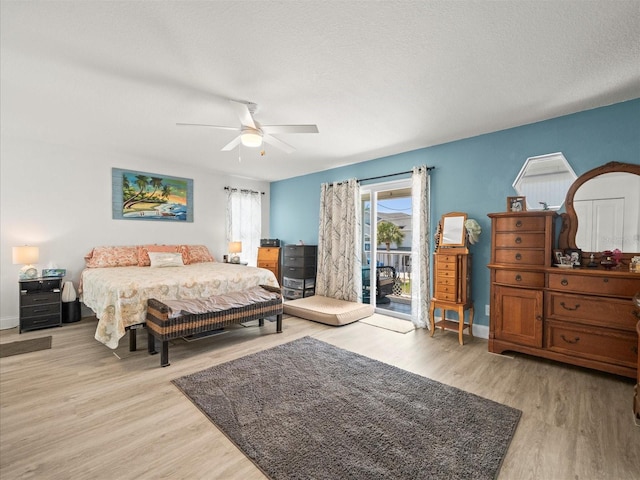 bedroom featuring baseboards, access to outside, ceiling fan, and wood finished floors