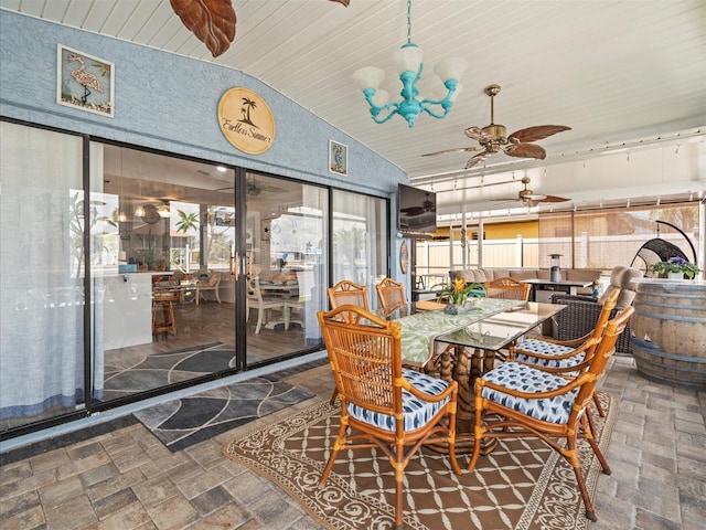 sunroom / solarium with plenty of natural light, outdoor dining area, and ceiling fan