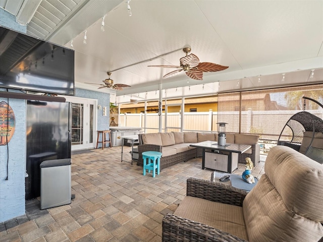 view of patio / terrace with an outdoor hangout area, ceiling fan, and fence