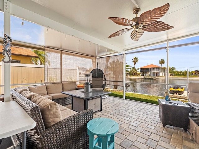 sunroom / solarium with a water view, an outdoor hangout area, and ceiling fan