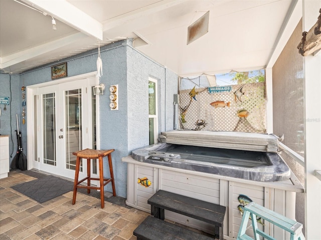 view of patio / terrace with a hot tub and french doors