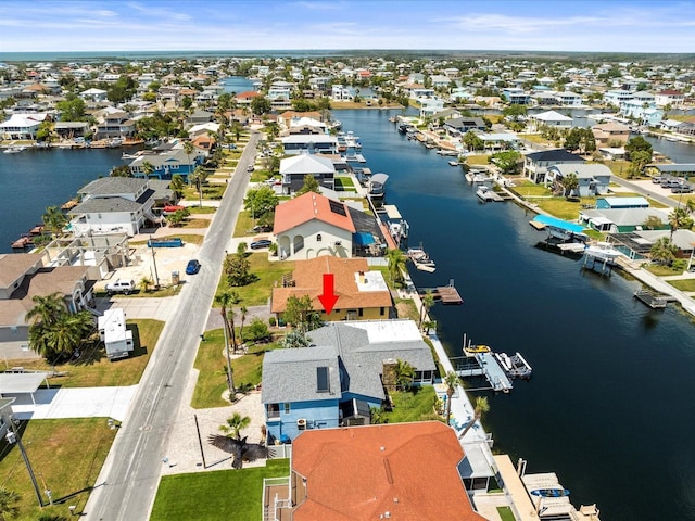 drone / aerial view with a water view and a residential view