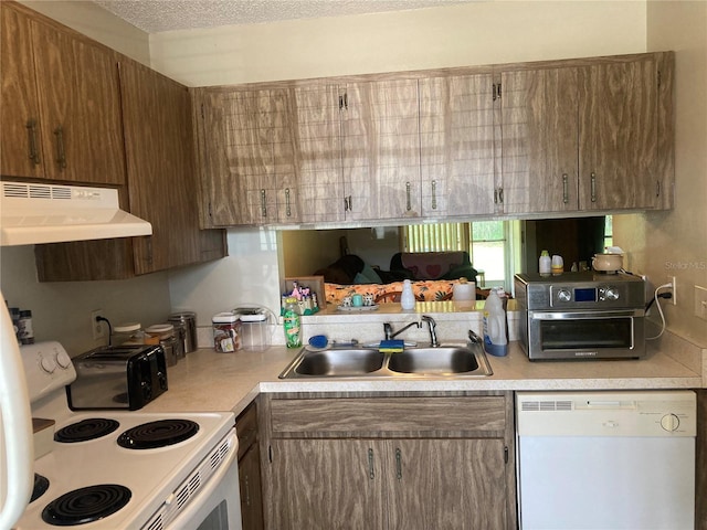 2850 Westmoreland Ct, New Port Richey, FL 34655 - kitchen featuring white appliances, a sink, under cabinet range hood, and light countertops