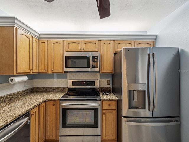 11512 Yellow Birch Ct, New Port Richey, FL 34654 - kitchen featuring stainless steel appliances, a ceiling fan, tasteful backsplash, and brown cabinetry