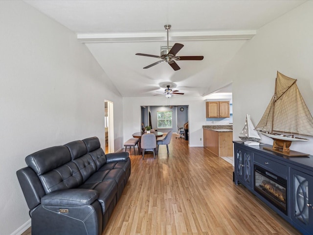 11512 Yellow Birch Ct, New Port Richey, FL 34654 - living room with light wood-type flooring, a ceiling fan, baseboards, and a glass covered fireplace