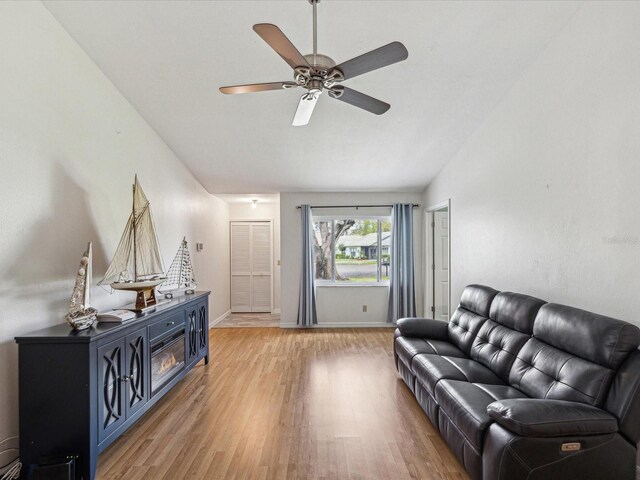 11512 Yellow Birch Ct, New Port Richey, FL 34654 - living area with light wood finished floors, a ceiling fan, and baseboards