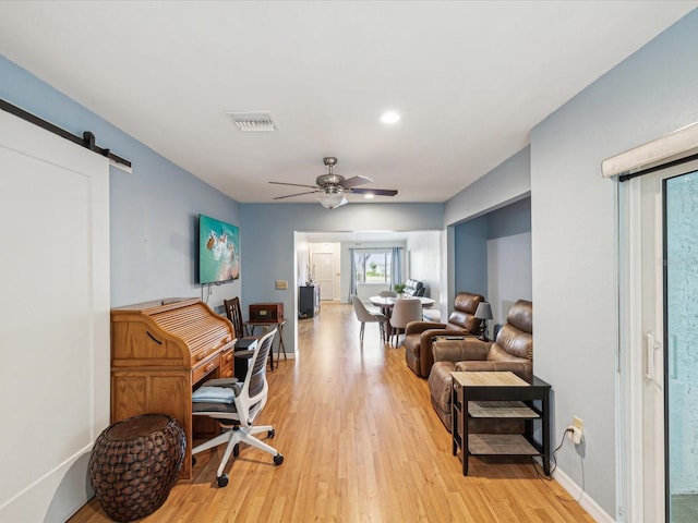 11512 Yellow Birch Ct, New Port Richey, FL 34654 - office area featuring light wood-type flooring, ceiling fan, a barn door, baseboards, and recessed lighting