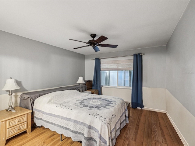 11512 Yellow Birch Ct, New Port Richey, FL 34654 - bedroom with light wood-style floors, a ceiling fan, and baseboards