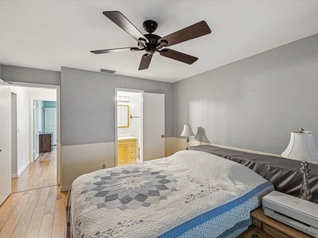 11512 Yellow Birch Ct, New Port Richey, FL 34654 - bedroom featuring light wood-style floors, baseboards, ceiling fan, and connected bathroom