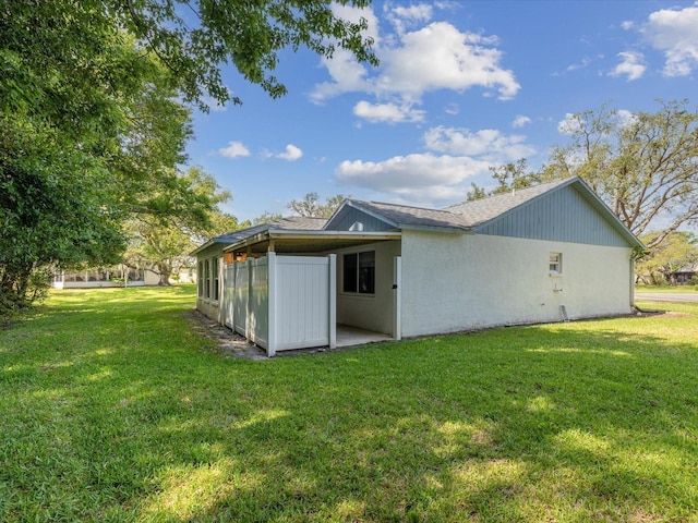 11512 Yellow Birch Ct, New Port Richey, FL 34654 - rear view of property featuring a lawn and stucco siding