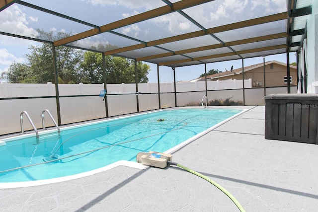 view of pool featuring a patio area, a lanai, fence, and a fenced in pool