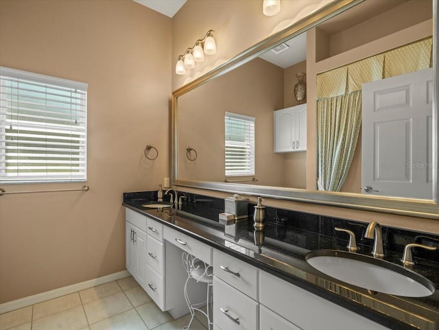 9216 Tarleton Cir, Weeki Wachee, FL 34613 - full bathroom with a sink, double vanity, baseboards, and tile patterned floors