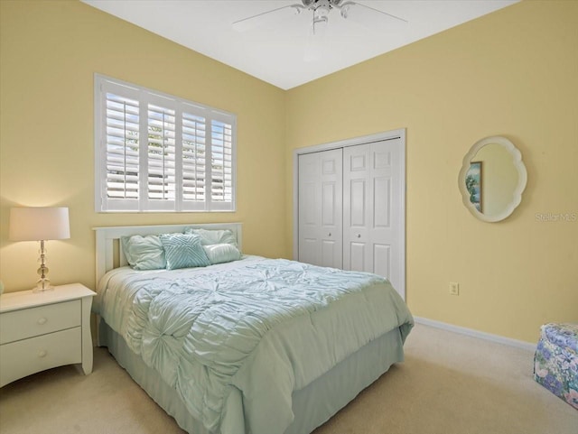 9216 Tarleton Cir, Weeki Wachee, FL 34613 - bedroom with a ceiling fan, light carpet, a closet, and baseboards