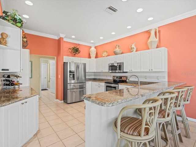 9216 Tarleton Cir, Weeki Wachee, FL 34613 - kitchen featuring visible vents, a sink, a peninsula, white cabinets, and appliances with stainless steel finishes