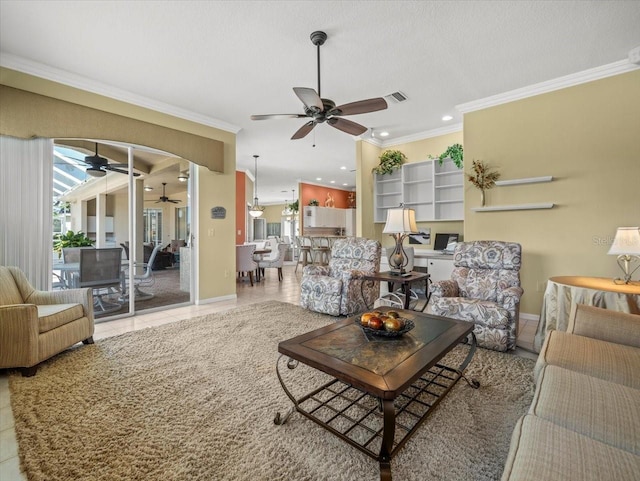 9216 Tarleton Cir, Weeki Wachee, FL 34613 - living room featuring ornamental molding, visible vents, ceiling fan, and plenty of natural light