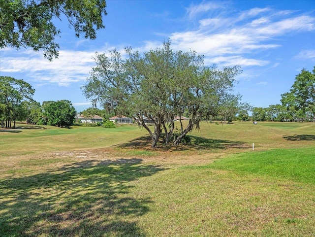 9216 Tarleton Cir, Weeki Wachee, FL 34613 - surrounding community with view of golf course and a lawn