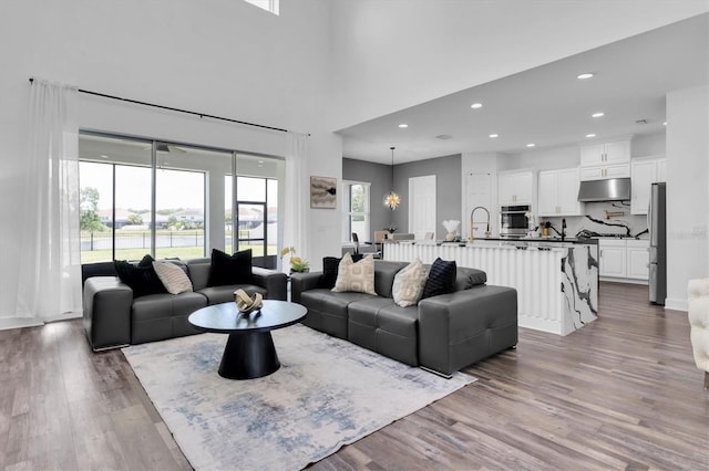 4188 Barbour Trl, Odessa, FL 33556 - living room featuring wood finished floors, recessed lighting, and a chandelier