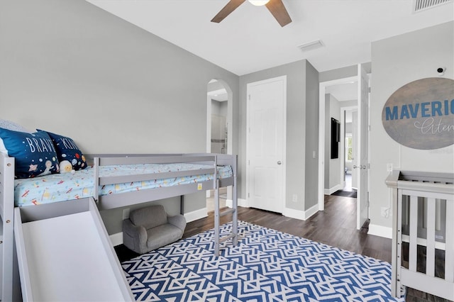 4188 Barbour Trl, Odessa, FL 33556 - bedroom with wood finished floors, arched walkways, baseboards, and ceiling fan