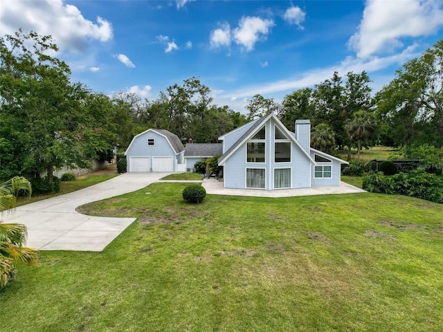 view of front of home with a chimney, an outbuilding, a garage, concrete driveway, and a front lawn