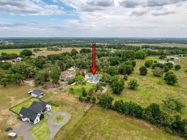 birds eye view of property with a rural view