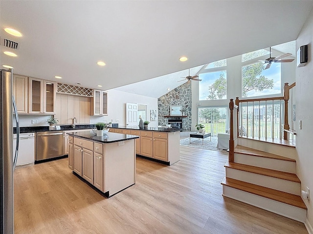 kitchen featuring a center island, ceiling fan, visible vents, light wood-style floors, and appliances with stainless steel finishes
