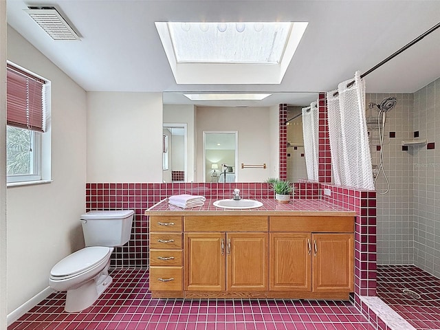 full bathroom with tiled shower, tile patterned floors, visible vents, and a skylight