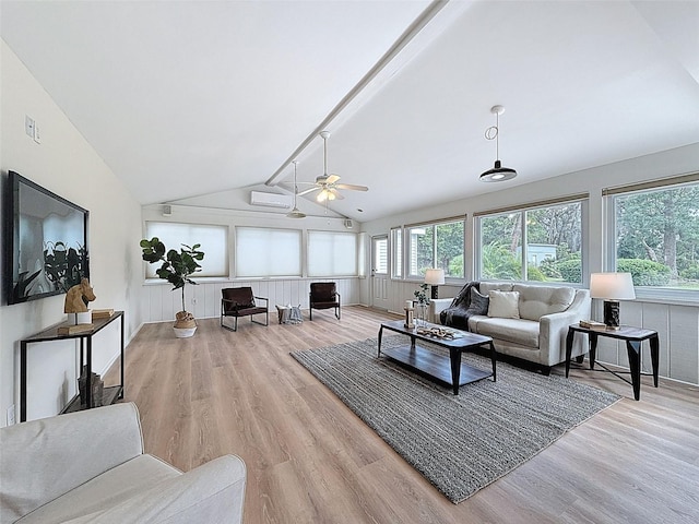 living room featuring vaulted ceiling with beams, ceiling fan, plenty of natural light, and wood finished floors
