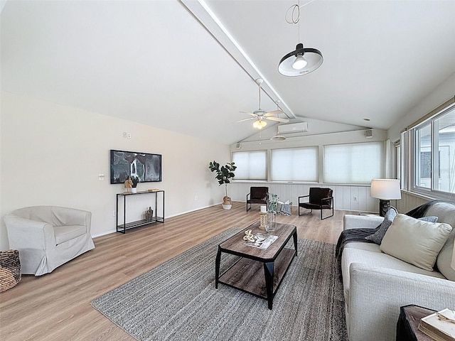living room with lofted ceiling with beams, a wall mounted air conditioner, ceiling fan, and wood finished floors