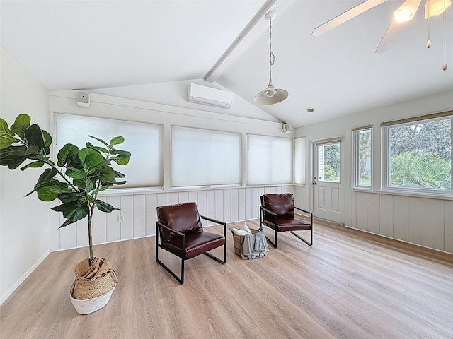sitting room with wood finished floors, lofted ceiling with beams, and a wall mounted AC