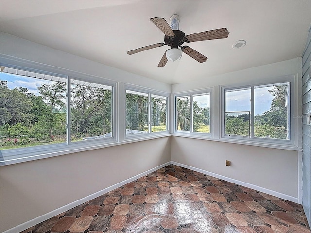 unfurnished sunroom featuring baseboards