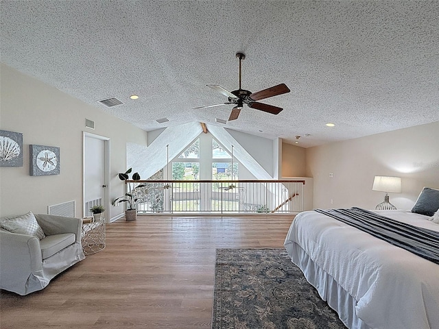 bedroom featuring visible vents and wood finished floors