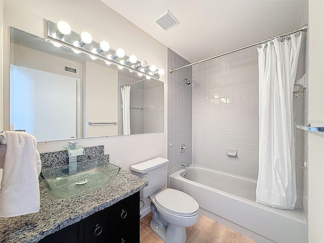 full bathroom featuring shower / bath combination with curtain, toilet, visible vents, and wood finished floors