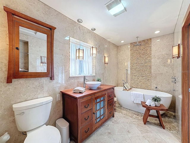bathroom with toilet, walk in shower, visible vents, a soaking tub, and vanity