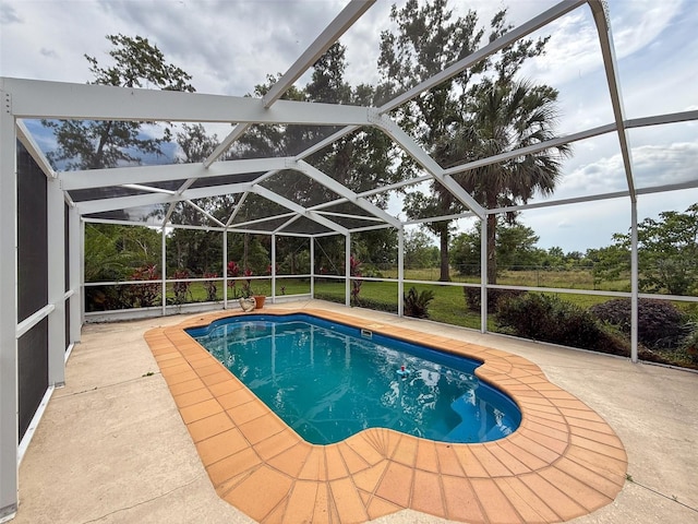 outdoor pool with a patio area and a lanai