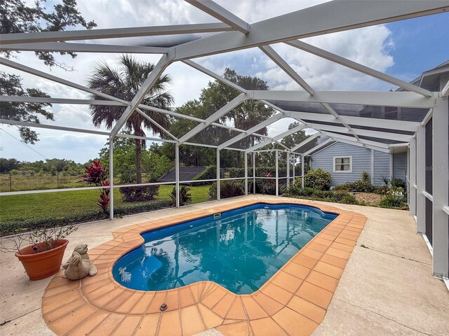 outdoor pool with a patio and a lanai