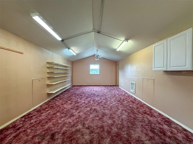 additional living space with carpet, visible vents, baseboards, and lofted ceiling