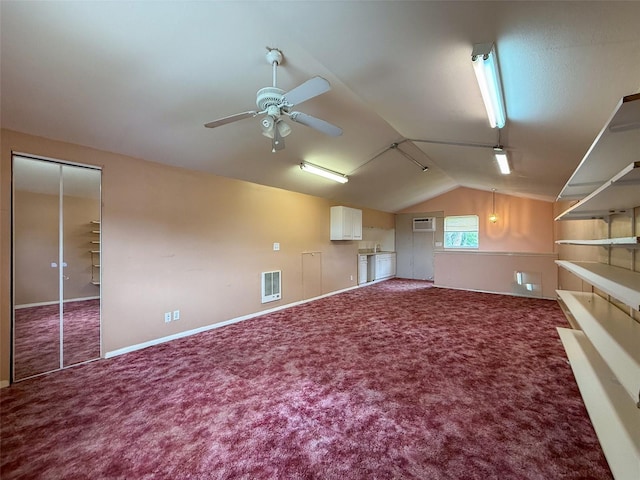 bonus room with lofted ceiling, a ceiling fan, a wall mounted air conditioner, carpet, and visible vents