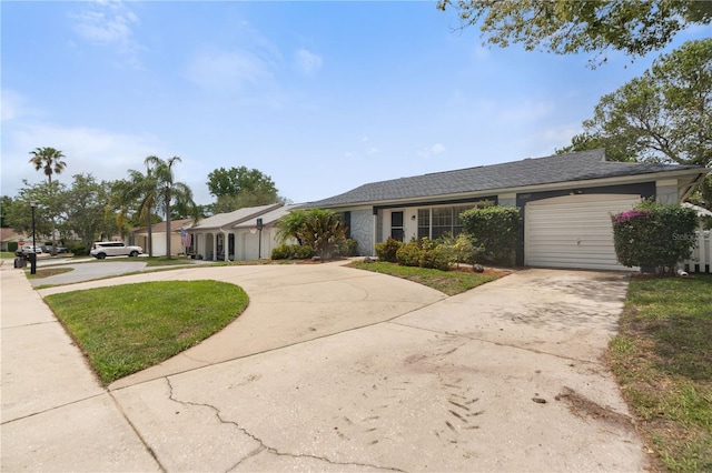 single story home with driveway and an attached garage