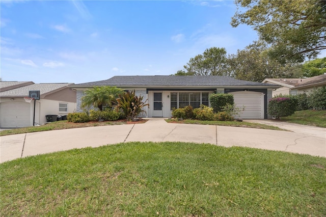 ranch-style house featuring concrete driveway, an attached garage, and a front yard
